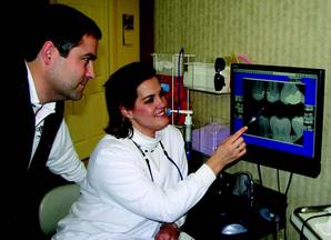 Tracy points out the features of digital X-ray to our patient
