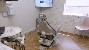 The dental treatment rooms are cozy but simple: Midmark chairs and cabinetry, along with plenty of natural daylight and TVs on the ceiling to distract patients during appointments.