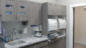 The sterilization room is designed and organized for ease of use, but with a tailored, stylized, natural-wood look.