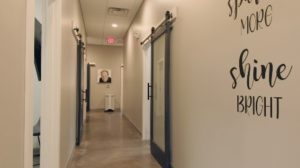 Vibrant portraits of smiling patients line the hallways, showcasing the beautiful smiles Dr. Suh and his team have created, adding to the cheerful feel of the practice