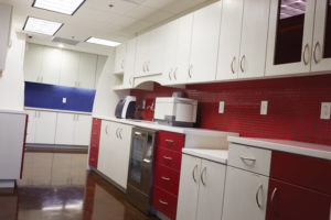 Fire engine red wall tiles and cabinetry communicate “caution.” This practical design clearly communicates the beginning of the instruments’ flow from dirty to clean.