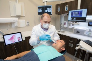 Dr. scanning patient with 3Shape TRIOS.