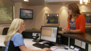 Receptionist and patient talking