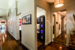 Natural elements like the brick wall and the reclaimed wood beams that run overhead, contrast beautifully with the sleek technology found in the rest of the office.