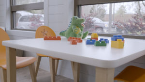 A kids’ corner with bright orange chairs featuring playful starfish cutouts.