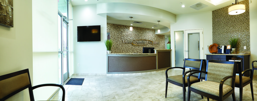 Stacked stone walls and a soft color scheme greet patients as they walk into the sunny, contemporary office.