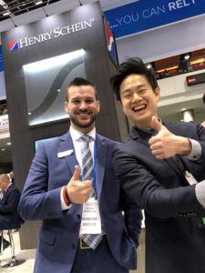 Dr. Ng (right) with a representative in the Henry Schein booth.