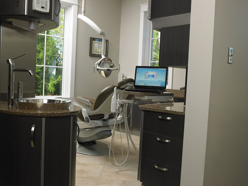 Operatories are an open-bay, rear-delivery layout, a change from her previous side-delivery design. Chairs and lights are by Pelton & Crane.