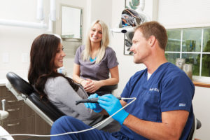 Dr. Clay uses the DEXIS CariVu to detect caries and cracks in a patient's tooth.